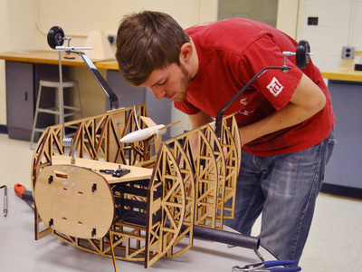 a student works on an aeronautical construction project