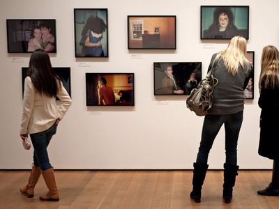 people view art on a gallery wall