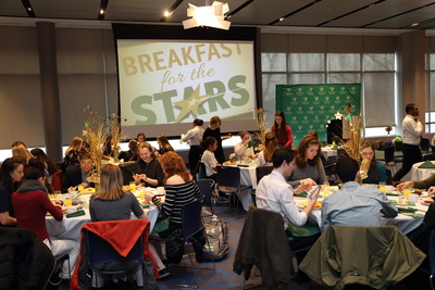 students sit at dining tables during the Breakfast for the Stars event