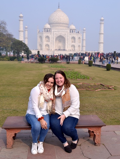 students seated in front of the Taj Mahal