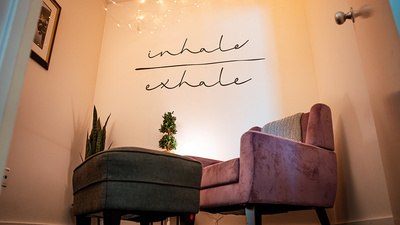 A soft chair and footstool in a cozy Zen room
