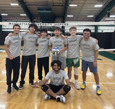 students pose with a volleyball in a gym