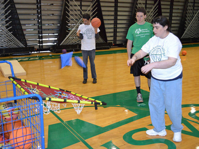 A student throws bean bags into a net