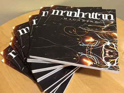 a stack of Manhattan Magazine publications on a table