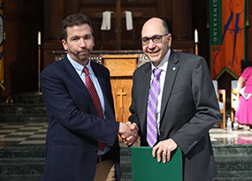 Kevin Ahern shaking hands with former MU president Dr. Milo Riverso