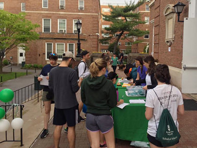 students visit tables to learn about how to serve the community
