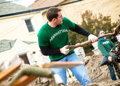 a student shovels soil as part of a service event
