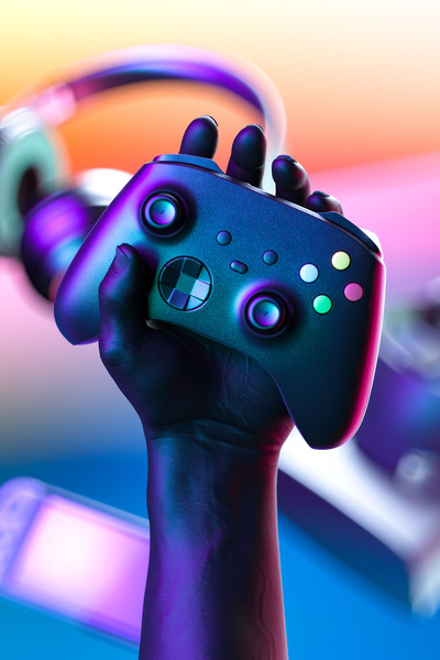 #D rendering of a hand Holding Wireless Joystick With Gaming Gamepad Controller, VR Goggles, Headphones, Video Game Console On Background.