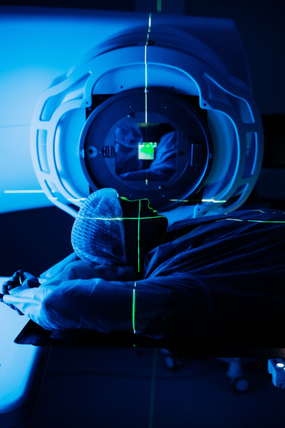 Linear accelerator in oncology treatment room, patient positioned for radiation therapy, with advanced technology