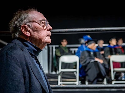 Image of author and Manhattan alum James Patterson standing during the 2026 commencement.