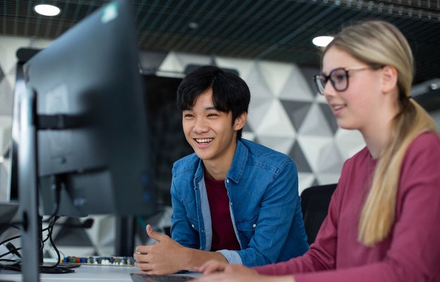 Manhattan University students looking at a monitor