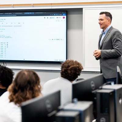 Manhattan University professor teaching in a business classroom