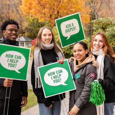 Manhattan University Admission counselors and students smiling during an open house event