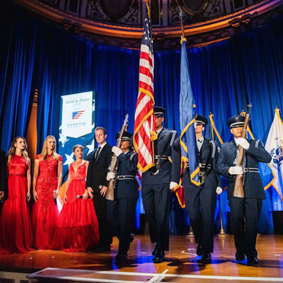 AFROTC color guard presents the colors during the Folded Flag Foundation gala ceremony on a formal stage.