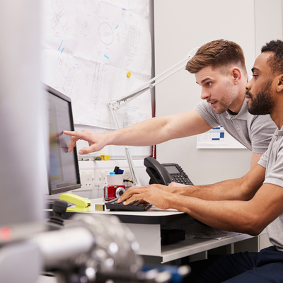 Male Engineers Use CMM Coordinate Measuring Machine In Factory