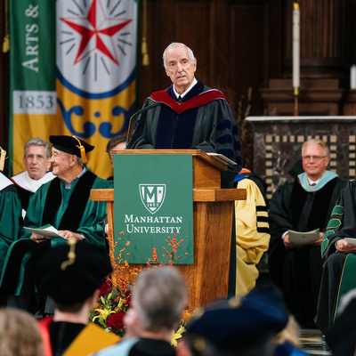 Guest speaker delivers remarks at the podium during the Manhattan University inauguration ceremony.