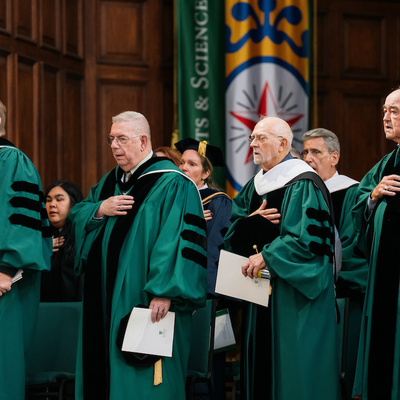 Academic leaders gather on stage during the Manhattan University presidential inauguration.