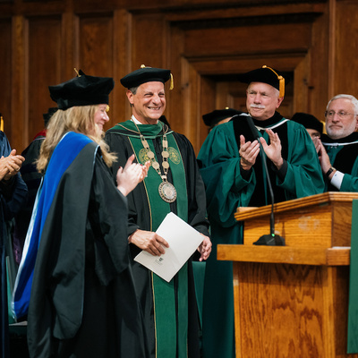 University leadership applauds as President Frederick Bonato is recognized during inauguration.