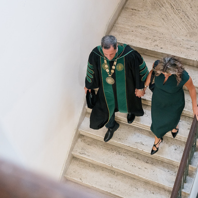 President Frederick Bonato walks down stairs following inauguration.