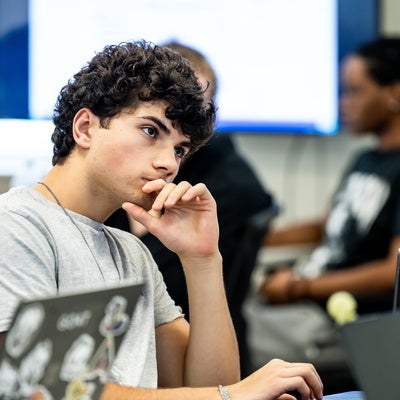 Manhattan University student focusing during a lecture