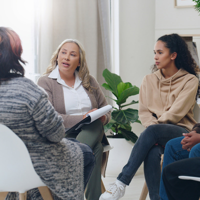 A group of people in a circle in therapy