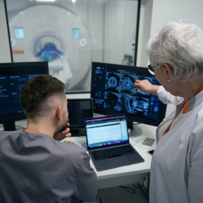 doctor and her colleague are analyzing results of CT