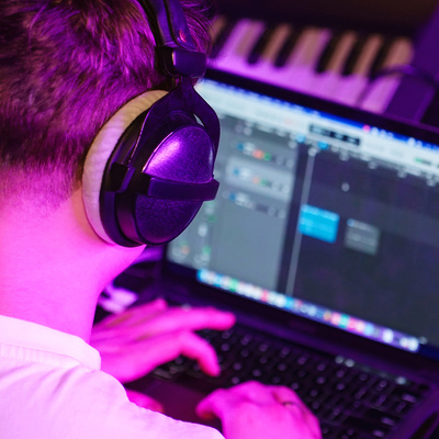 Student Focuses Editing Track with Headphones On