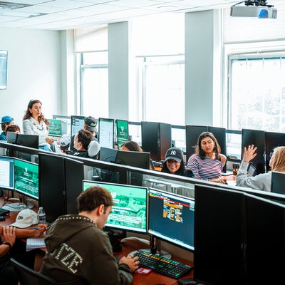 Photo showing the Bloomberg Lab in the O'Malley School of Business at Manhattan University with students and faculty